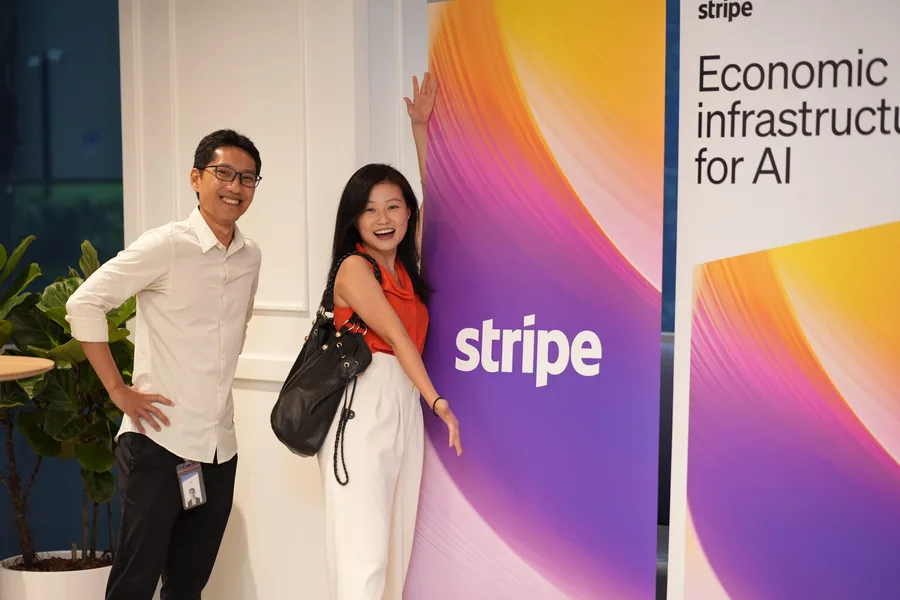 Convergence Summit attendees near the Stripe event wall