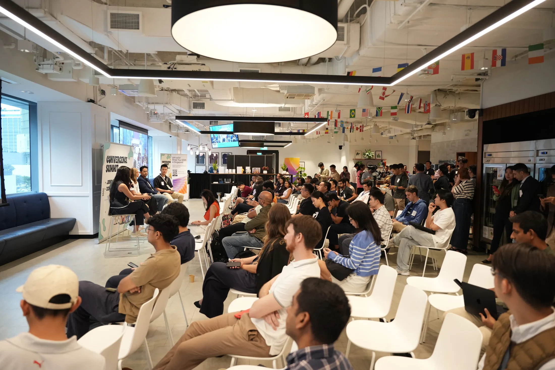 The audience raising hands during a Q&A session at Convergence Summit in Singapore