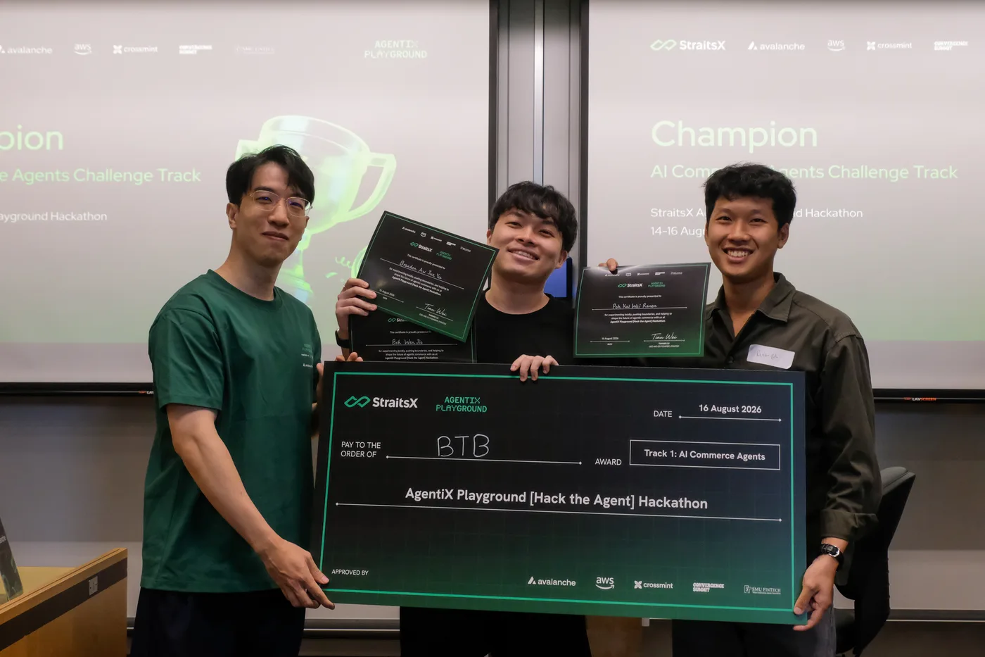 Challenge track champions holding a sponsor-branded prize cheque