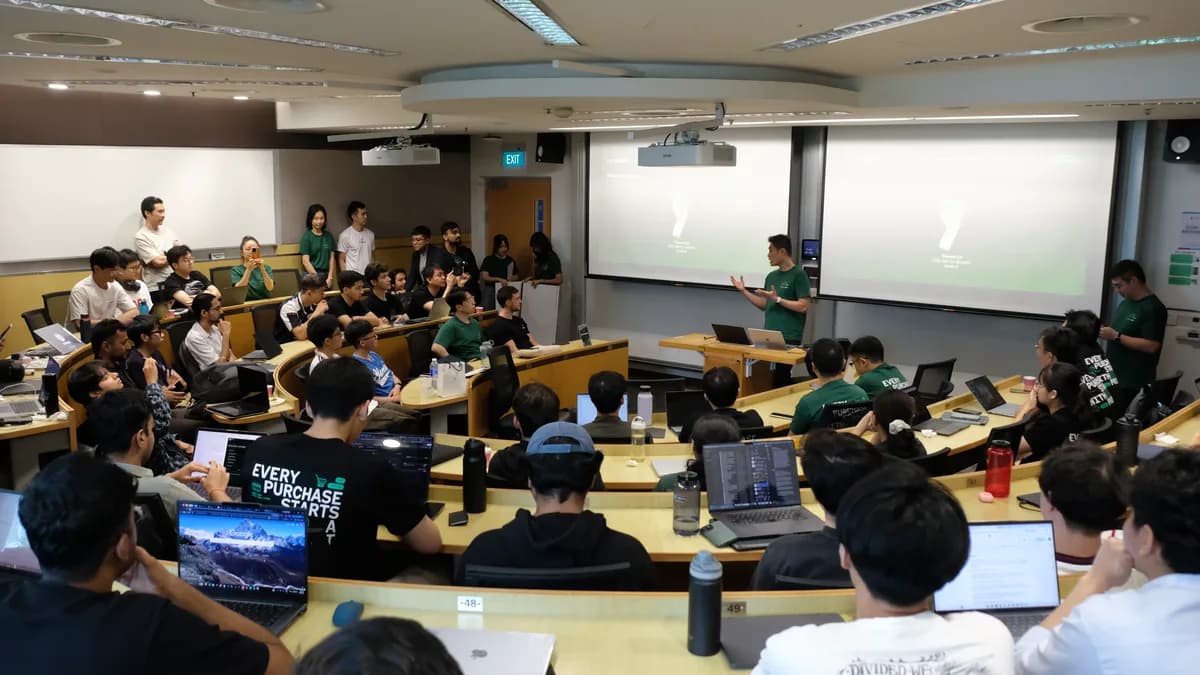 A full lecture theatre of hackathon participants during final presentations