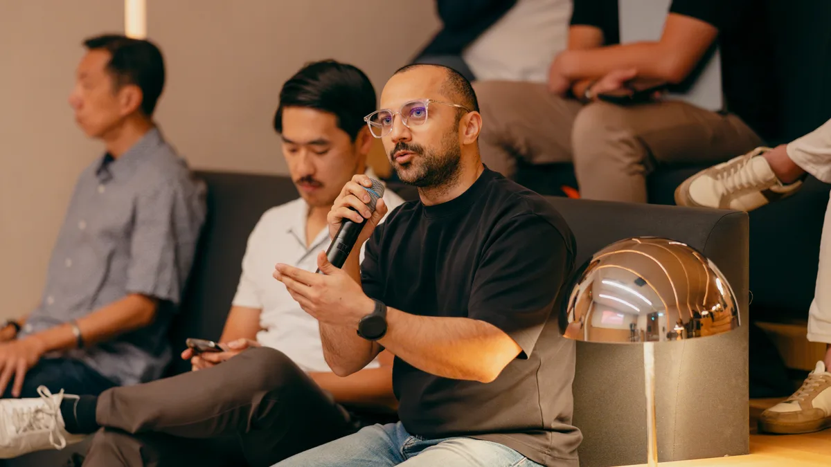 A senior leader putting a question to the panel at a Convergence session
